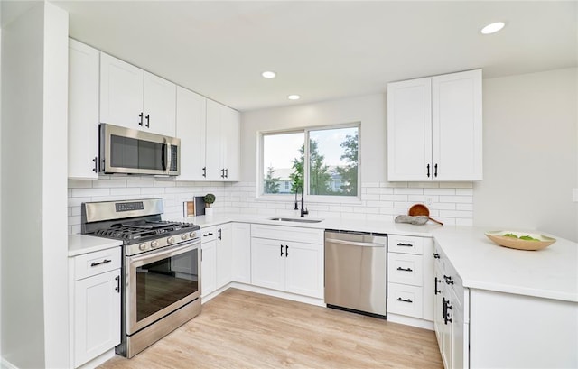 7219 Watsons Parish Dr, Ofallon, MO 63368 - kitchen featuring stainless steel appliances, a sink, recessed lighting, tasteful backsplash, and a peninsula