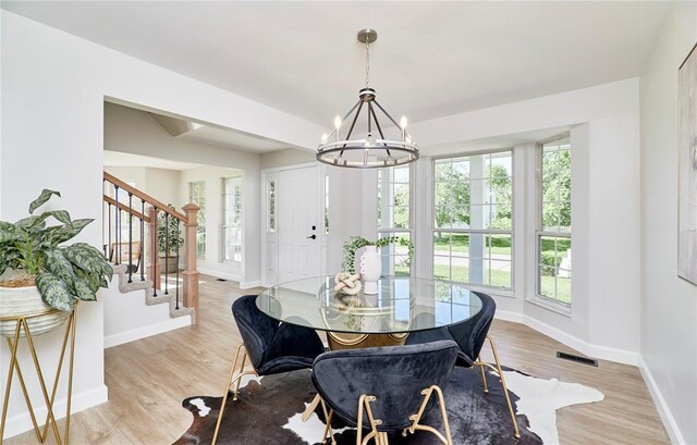 7219 Watsons Parish Dr, Ofallon, MO 63368 - dining space with a chandelier, plenty of natural light, and baseboards