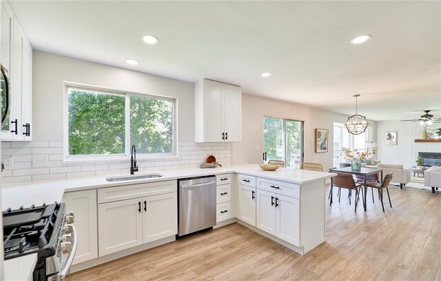 7219 Watsons Parish Dr, Ofallon, MO 63368 - kitchen with stainless steel appliances, a sink, backsplash, white cabinets, and recessed lighting
