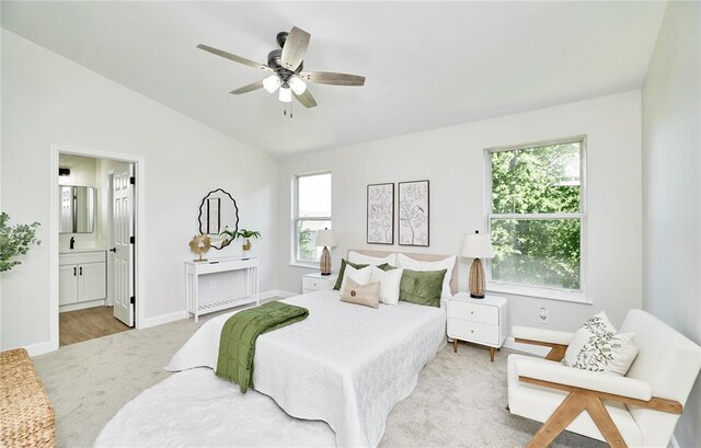 7219 Watsons Parish Dr, Ofallon, MO 63368 - bedroom featuring vaulted ceiling, light carpet, ensuite bath, baseboards, and a ceiling fan