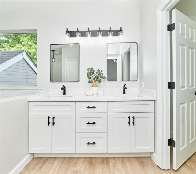 7219 Watsons Parish Dr, Ofallon, MO 63368 - bathroom featuring double vanity, wood finished floors, and baseboards