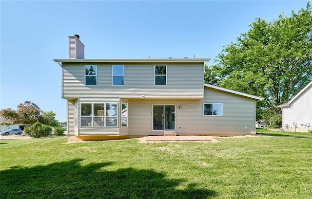 7219 Watsons Parish Dr, Ofallon, MO 63368 - back of property with a yard, a patio, and a chimney