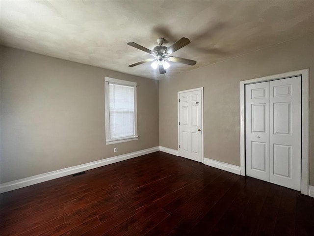 1638 Poplar St, Granite City, IL 62040 - unfurnished bedroom featuring dark wood-style flooring, baseboards, and a ceiling fan