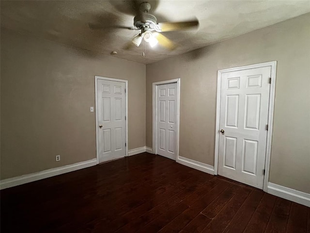 1638 Poplar St, Granite City, IL 62040 - unfurnished bedroom featuring dark wood finished floors, baseboards, and a ceiling fan