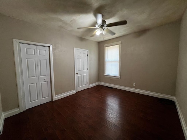 1638 Poplar St, Granite City, IL 62040 - unfurnished bedroom with dark wood-style flooring, baseboards, and a ceiling fan