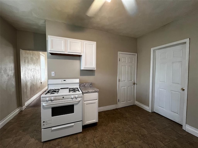 1638 Poplar St, Granite City, IL 62040 - kitchen with white gas range oven, white cabinets, and baseboards