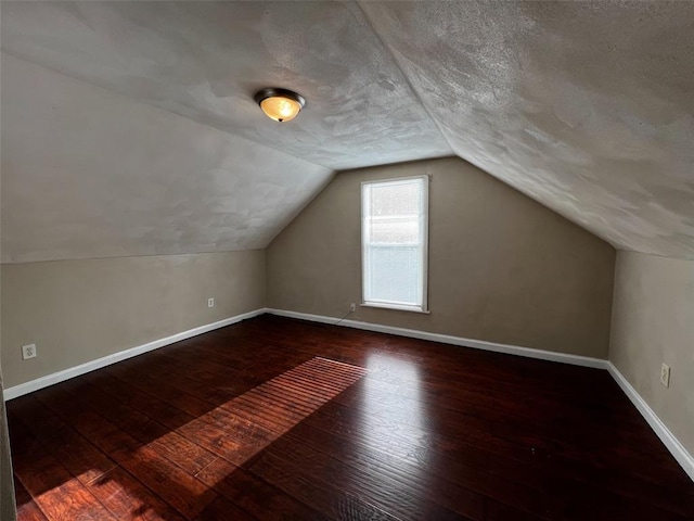 1638 Poplar St, Granite City, IL 62040 - additional living space featuring hardwood / wood-style floors, baseboards, a textured ceiling, and lofted ceiling