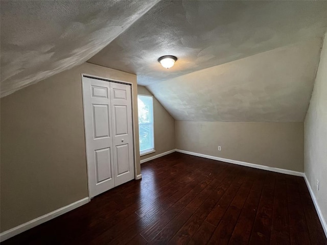 1638 Poplar St, Granite City, IL 62040 - bonus room with baseboards, hardwood / wood-style flooring, a textured ceiling, and lofted ceiling