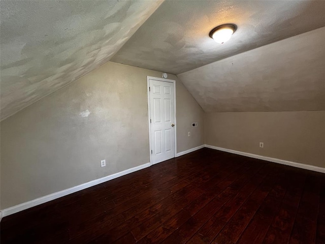 1638 Poplar St, Granite City, IL 62040 - additional living space with baseboards, hardwood / wood-style flooring, lofted ceiling, and a textured ceiling
