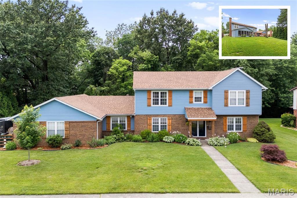 1013 N Smiley St, Ofallon, IL 62269 - traditional-style house featuring brick siding, a front lawn, and roof with shingles