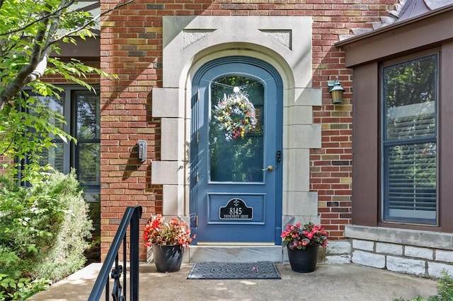 8145 University Dr, Clayton, MO 63105 - doorway to property featuring brick siding
