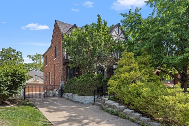 8145 University Dr, Clayton, MO 63105 - view of front of home with brick siding and concrete driveway