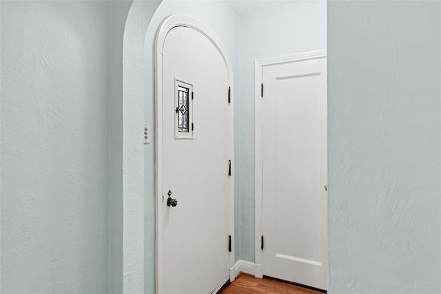 8145 University Dr, Clayton, MO 63105 - hallway with light wood-style floors and arched walkways