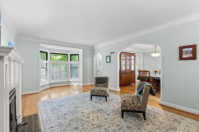 8145 University Dr, Clayton, MO 63105 - living area with arched walkways, wood finished floors, and baseboards