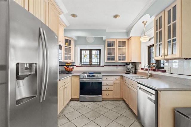 8145 University Dr, Clayton, MO 63105 - kitchen with stainless steel appliances, a sink, light brown cabinetry, healthy amount of natural light, and crown molding