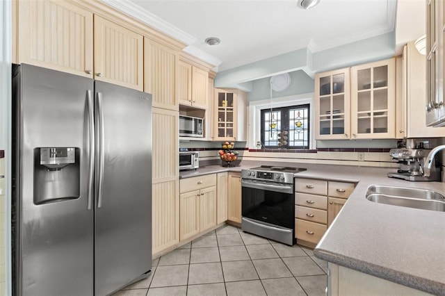 8145 University Dr, Clayton, MO 63105 - kitchen featuring appliances with stainless steel finishes, a sink, crown molding, cream cabinets, and light tile patterned floors
