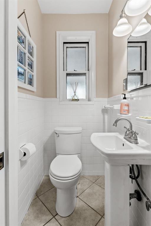 8145 University Dr, Clayton, MO 63105 - half bath with toilet, tile patterned flooring, tile walls, and wainscoting