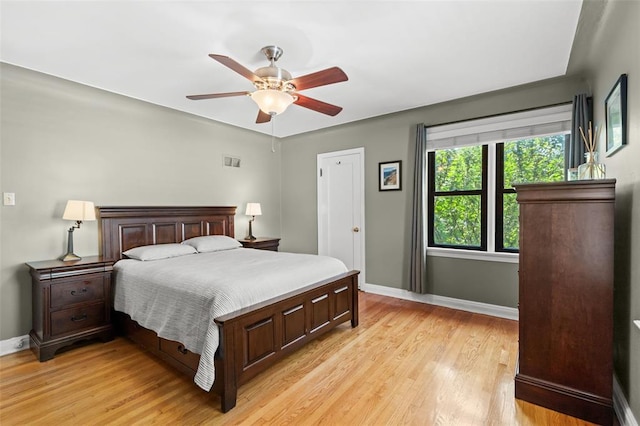 8145 University Dr, Clayton, MO 63105 - bedroom with baseboards, light wood-style floors, and a ceiling fan