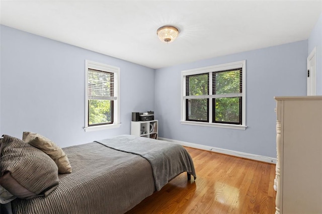 8145 University Dr, Clayton, MO 63105 - bedroom with light wood-type flooring and baseboards