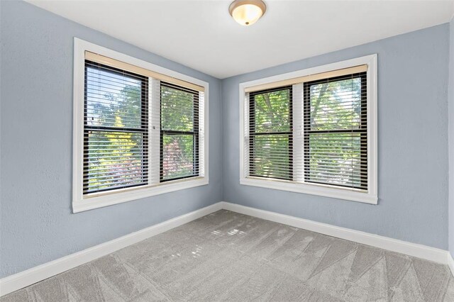 8145 University Dr, Clayton, MO 63105 - unfurnished room with baseboards and carpet