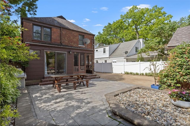 8145 University Dr, Clayton, MO 63105 - back of property featuring a patio, brick siding, and entry steps