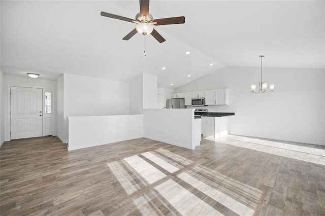 917 Gimli Ln, Wright City, MO 63390 - unfurnished living room with a ceiling fan, a chandelier, light wood-style flooring, lofted ceiling, and recessed lighting