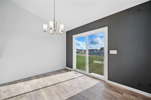 917 Gimli Ln, Wright City, MO 63390 - unfurnished dining area with a chandelier, wood finished floors, and baseboards