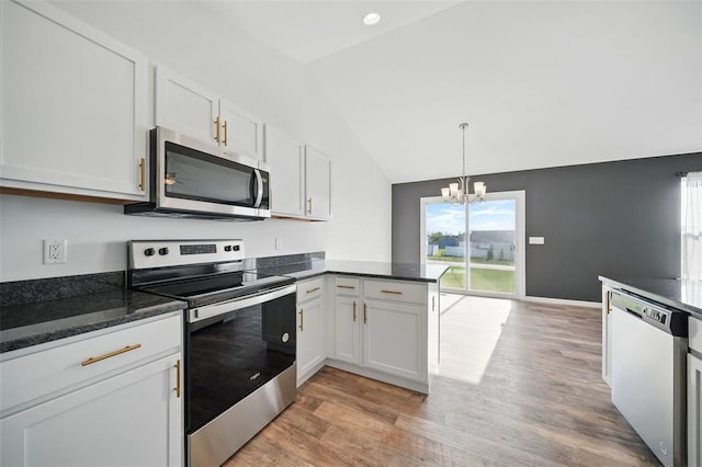 917 Gimli Ln, Wright City, MO 63390 - kitchen with appliances with stainless steel finishes, vaulted ceiling, light wood-style flooring, a chandelier, and white cabinetry