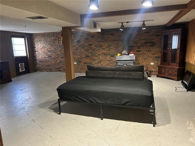 2 Graham Dr, Union, MO 63084 - bedroom with a wood stove, brick wall, concrete floors, and rail lighting