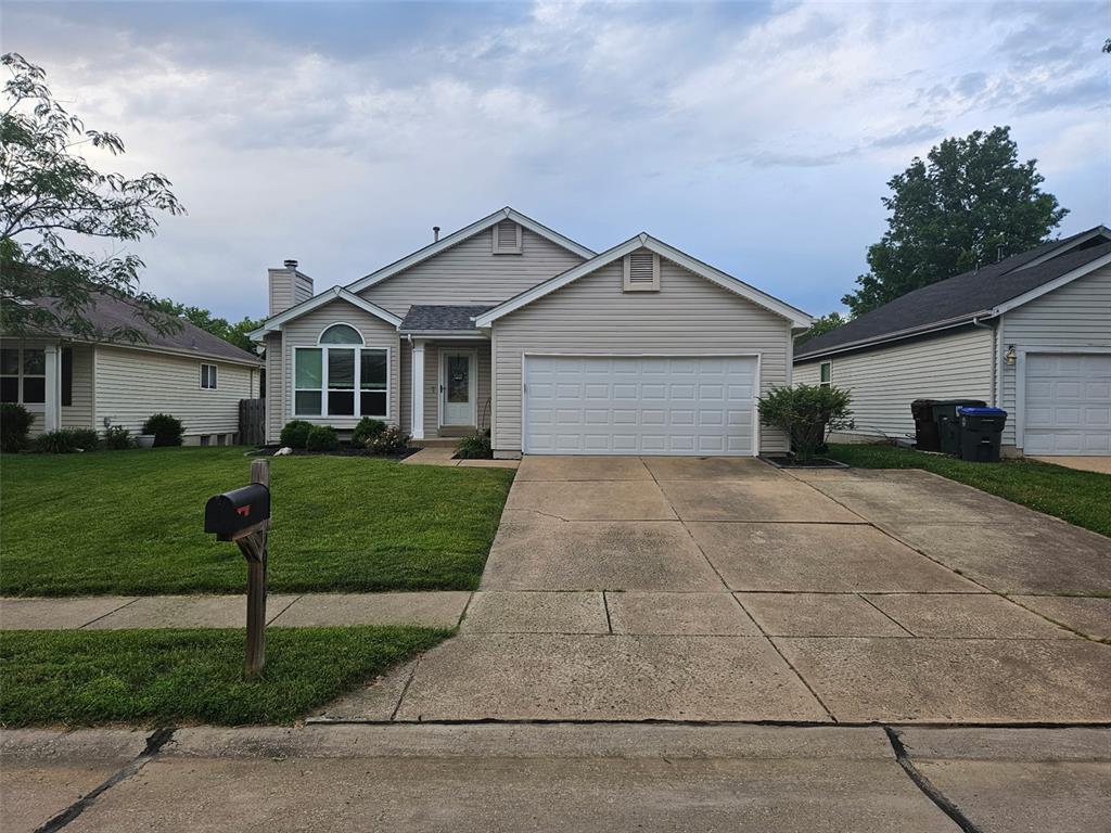 5072 Danielle Dr, Cottleville, MO 63304 - single story home with a front lawn, a garage, and driveway