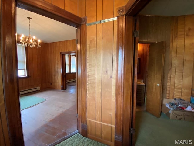405 W 18th St, Hermann, MO 65041 - hallway featuring a baseboard heating unit, wood walls, a chandelier, and carpet