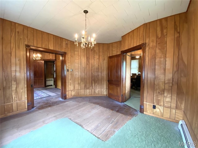 405 W 18th St, Hermann, MO 65041 - unfurnished room featuring a baseboard radiator, wooden walls, radiator, light wood finished floors, and a chandelier