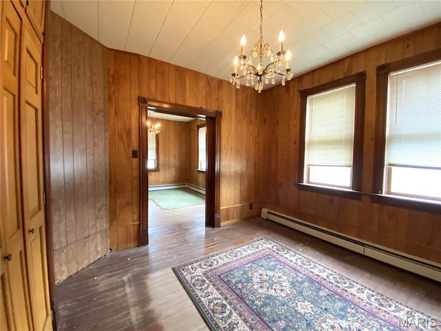 405 W 18th St, Hermann, MO 65041 - unfurnished dining area with a chandelier, hardwood / wood-style flooring, a baseboard radiator, and wooden walls
