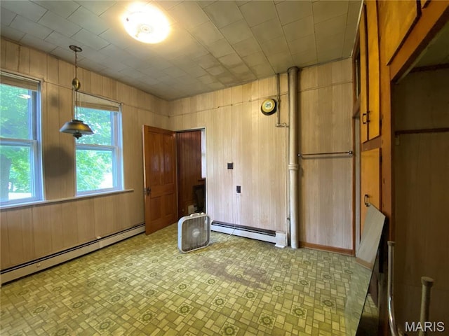405 W 18th St, Hermann, MO 65041 - unfurnished bedroom with baseboard heating, tile patterned floors, and wood walls