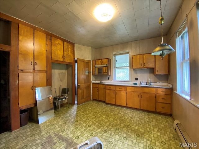 405 W 18th St, Hermann, MO 65041 - kitchen with a baseboard heating unit, brown cabinets, and plenty of natural light
