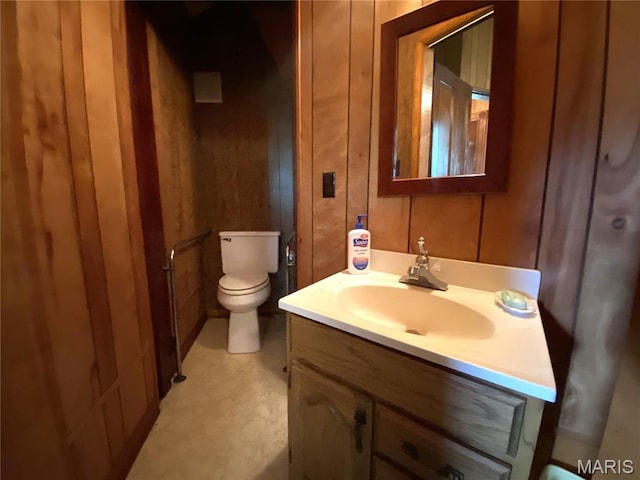 405 W 18th St, Hermann, MO 65041 - bathroom with vanity, toilet, and wooden walls