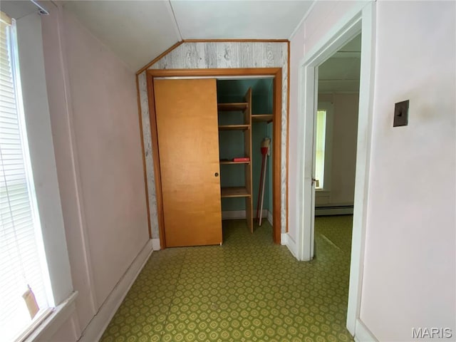 405 W 18th St, Hermann, MO 65041 - hallway featuring baseboard heating, lofted ceiling, baseboards, and tile patterned floors