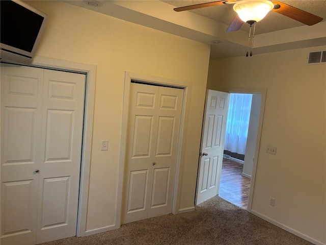 603 Capps Ave, Nokomis, IL 62075 - unfurnished bedroom with carpet floors, two closets, baseboards, and a ceiling fan
