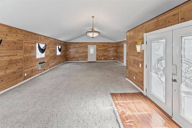 21604 Fox Dr, Carlyle, IL 62231 - foyer entrance featuring wooden walls, vaulted ceiling, light colored carpet, and an AC wall unit
