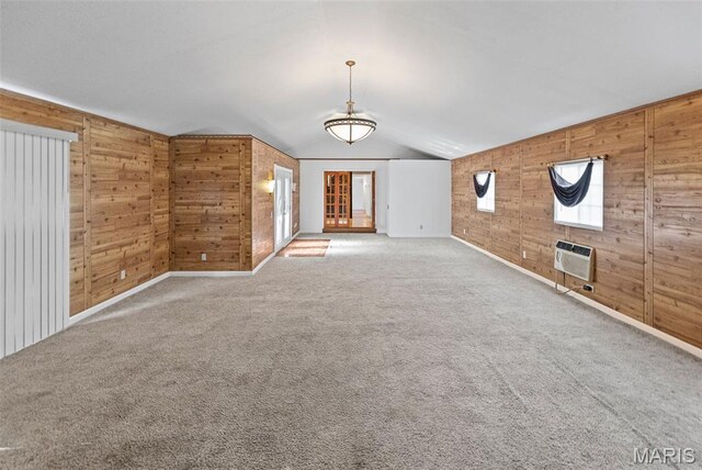 21604 Fox Dr, Carlyle, IL 62231 - unfurnished living room with wood walls, vaulted ceiling, a wall mounted air conditioner, and carpet flooring