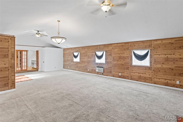 21604 Fox Dr, Carlyle, IL 62231 - unfurnished living room featuring ceiling fan, lofted ceiling, carpet flooring, wooden walls, and an AC wall unit