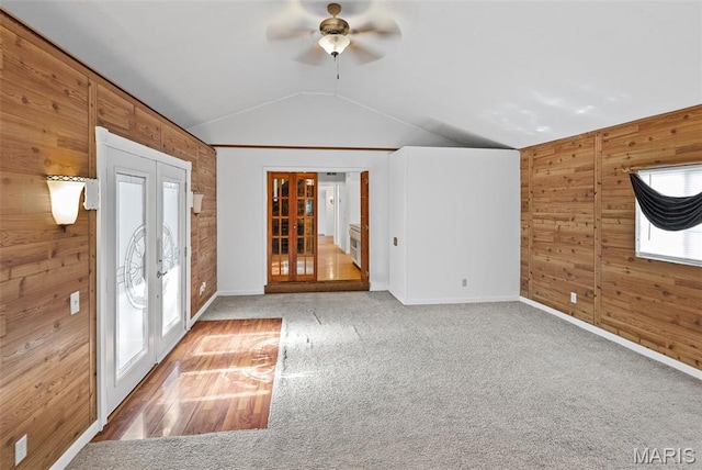 21604 Fox Dr, Carlyle, IL 62231 - unfurnished room with wooden walls, vaulted ceiling, french doors, a ceiling fan, and carpet flooring
