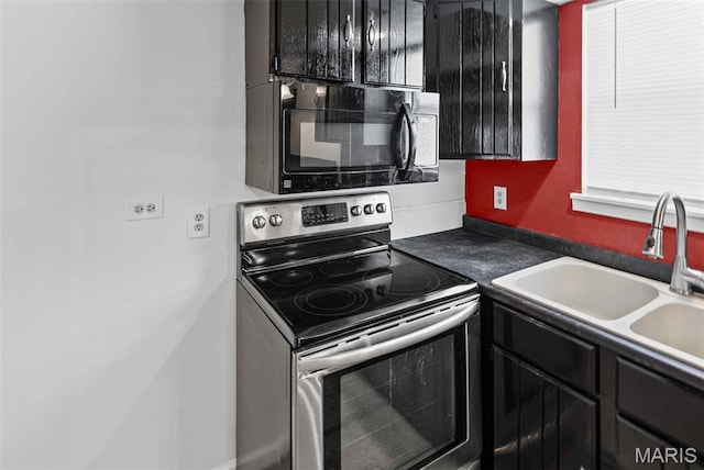 21604 Fox Dr, Carlyle, IL 62231 - kitchen with stainless steel range with electric cooktop, black microwave, dark cabinetry, and dark countertops