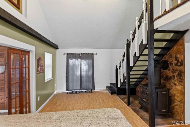 21604 Fox Dr, Carlyle, IL 62231 - foyer featuring wood finished floors, lofted ceiling, stairway, and a wood stove