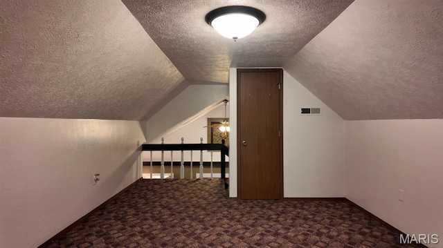 21604 Fox Dr, Carlyle, IL 62231 - additional living space with a textured ceiling, carpet floors, and vaulted ceiling