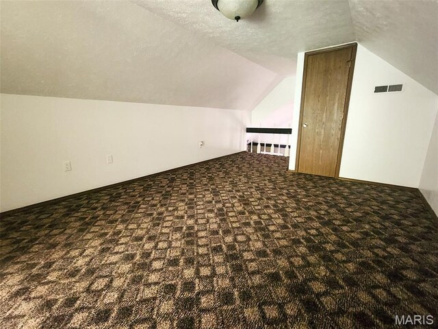 21604 Fox Dr, Carlyle, IL 62231 - additional living space featuring carpet, vaulted ceiling, and a textured ceiling