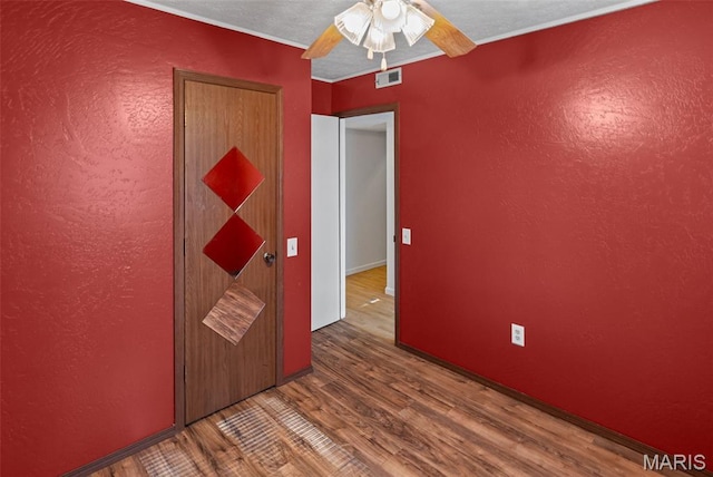 21604 Fox Dr, Carlyle, IL 62231 - unfurnished room with wood finished floors, a ceiling fan, and crown molding