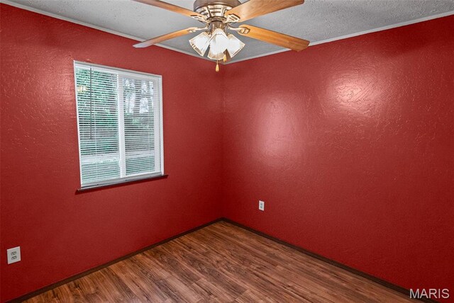 21604 Fox Dr, Carlyle, IL 62231 - unfurnished room featuring wood finished floors, a textured ceiling, a ceiling fan, and a textured wall