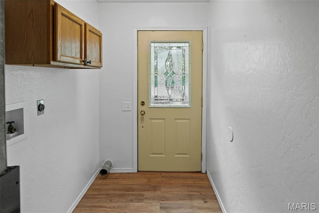 21604 Fox Dr, Carlyle, IL 62231 - washroom with hookup for an electric dryer, wood finished floors, cabinet space, hookup for a washing machine, and a textured wall