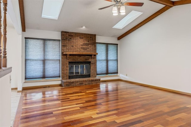1101 Claycrest Dr, Cottleville Township, MO 63304 - unfurnished living room with a skylight, ceiling fan, wood finished floors, a fireplace, and baseboards